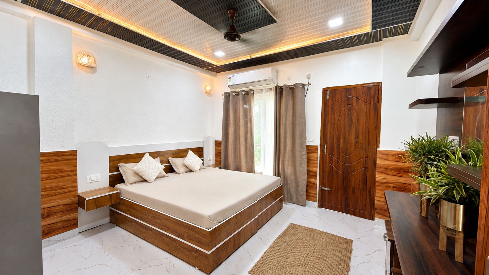 King bed room with warm ceiling lights and balcony curtains