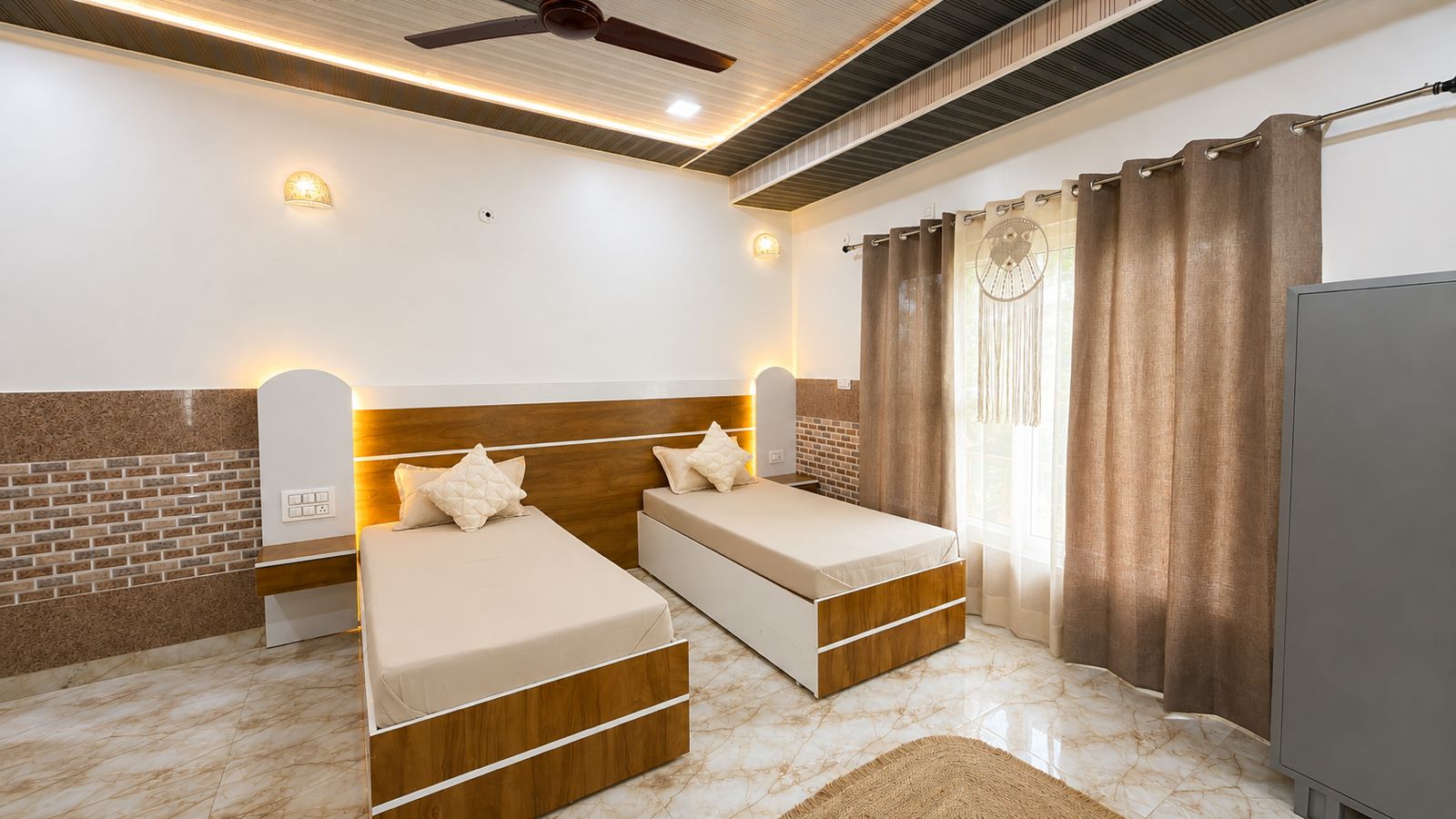 Bright twin room with two single beds and warm lighting