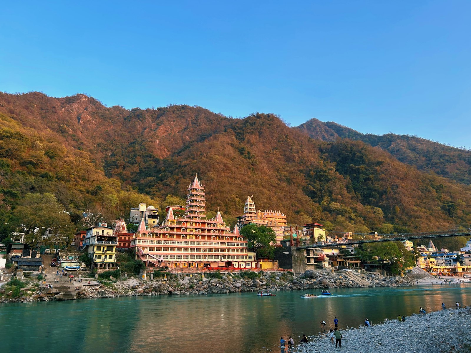 Tera Manzil temple and Lakshman Jhula on the Ganga at Rishikesh, golden hour